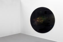 Jonathan Sullam, Champagne taste lemonade money, 2015, Aluminum black coated disk, holographic powder and light projector, 200 x 200 cm
