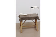 Pieter Laurens Mol, Method and Mode (The Germ), 2001, Plaster casts on steel bracket, 4.5 voltage battery, electrical wire with blinking led, cotton fabric, wooden bench, 91 x 79 x 40 cm