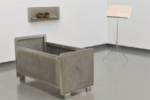 Pieter Laurens Mol, Lament Superior, 1991, Zinced steel constructions (bed, wall shelf and tripod), red lead on musical score paper, two blackbird’s nests, 123 x 84.5 x 76.5 cm (bed size), 87.5 x 32.5 x 21.5 cm (shelf size), (courtesy of the Artist and Van Gogh Museum, Amsterdam)